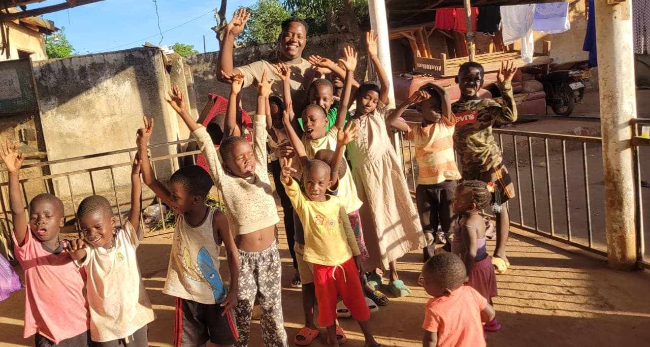 Mulindwa Kevin Oton with children at Army of God Children's Charity
